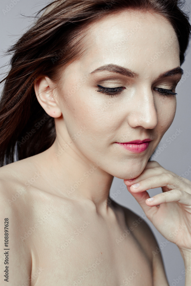 Beauty portrait of a pretty girl with makeup matte shadows on the eyes and pink lips Beauty portrait of a pretty girl with makeup matte shadows on the eyes and pink lips