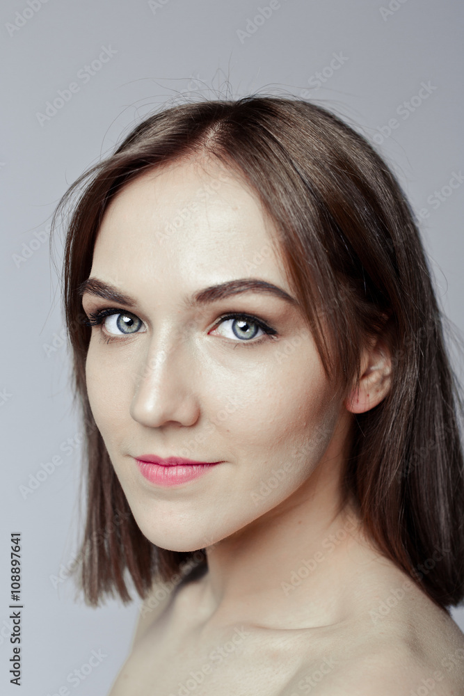 Beauty portrait of a pretty girl with makeup matte shadows on the eyes and pink lips