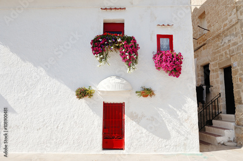 Fotografie characteristic house with flowers at the window in Monopoli near Bari, Apulia, I