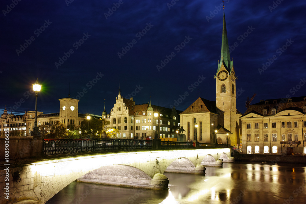 Night photo of Fraumunster Church and bridge over Limmat River, city of Zurich, Switzerland