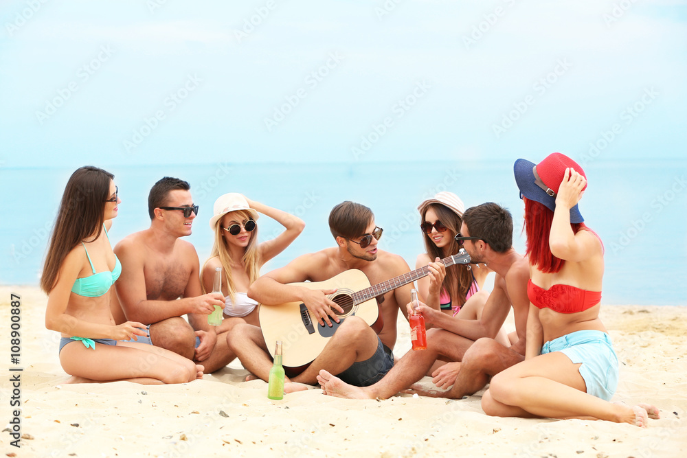 Beautiful young people with guitar having fun on beach Beautiful young people with guitar having fun on beach