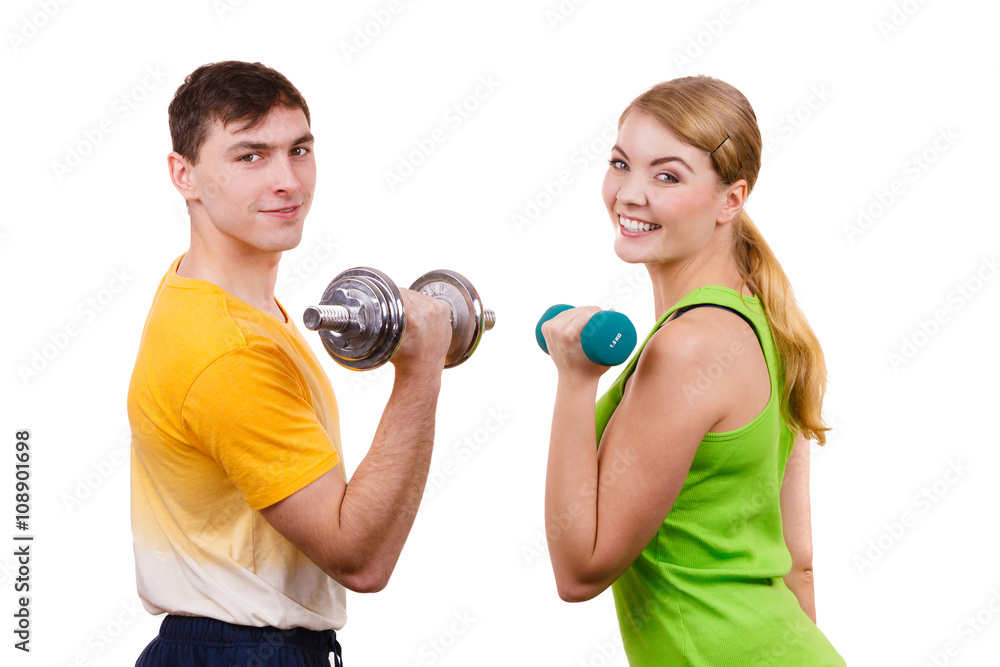Couple exercising with dumbbells lifting weights Couple exercising with dumbbells lifting weights
