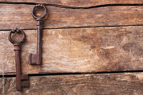 Old keys on wooden background, copy space