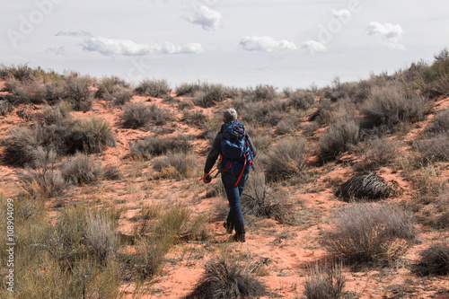 Man with backpack walks on deserted land