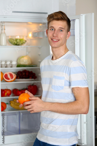 Handsome man taking food fr...