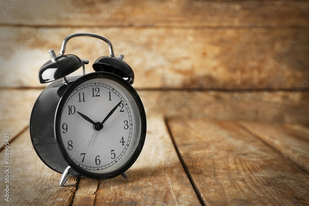 Alarm clock on old wooden table. Alarm clock on old wooden table.