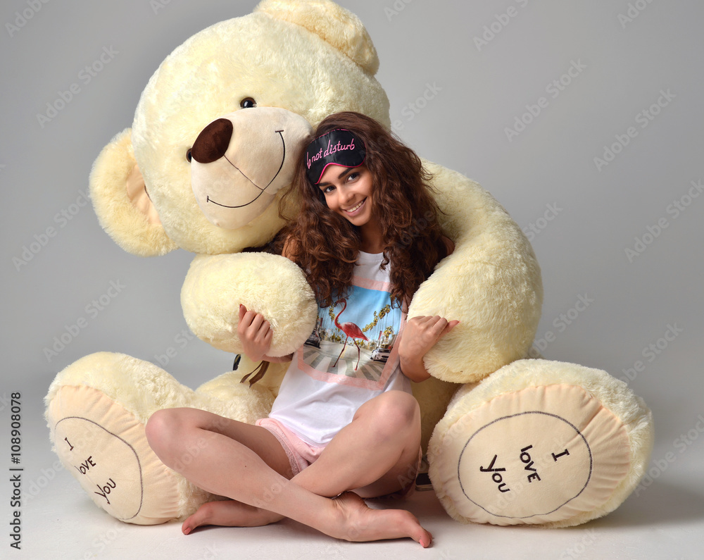 Young beautiful girl hugging big teddy bear soft toy happy smili ...