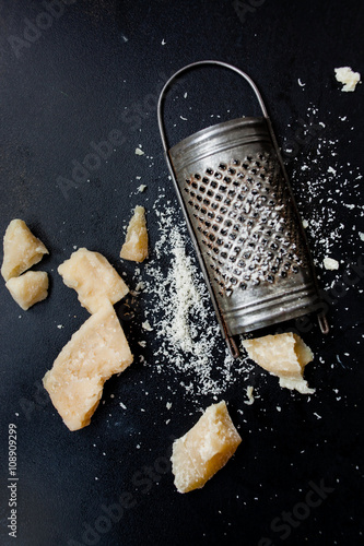 Fényképezés Parmesan cheese with a grater