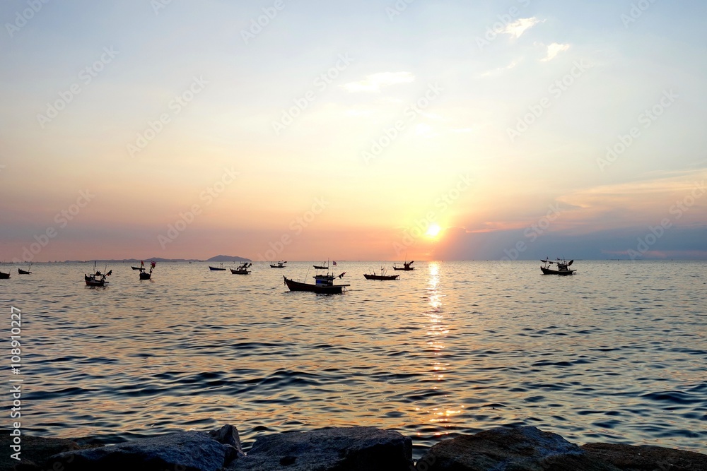 Fishing boats in sea on sunset Fishing boats in sea on sunset
