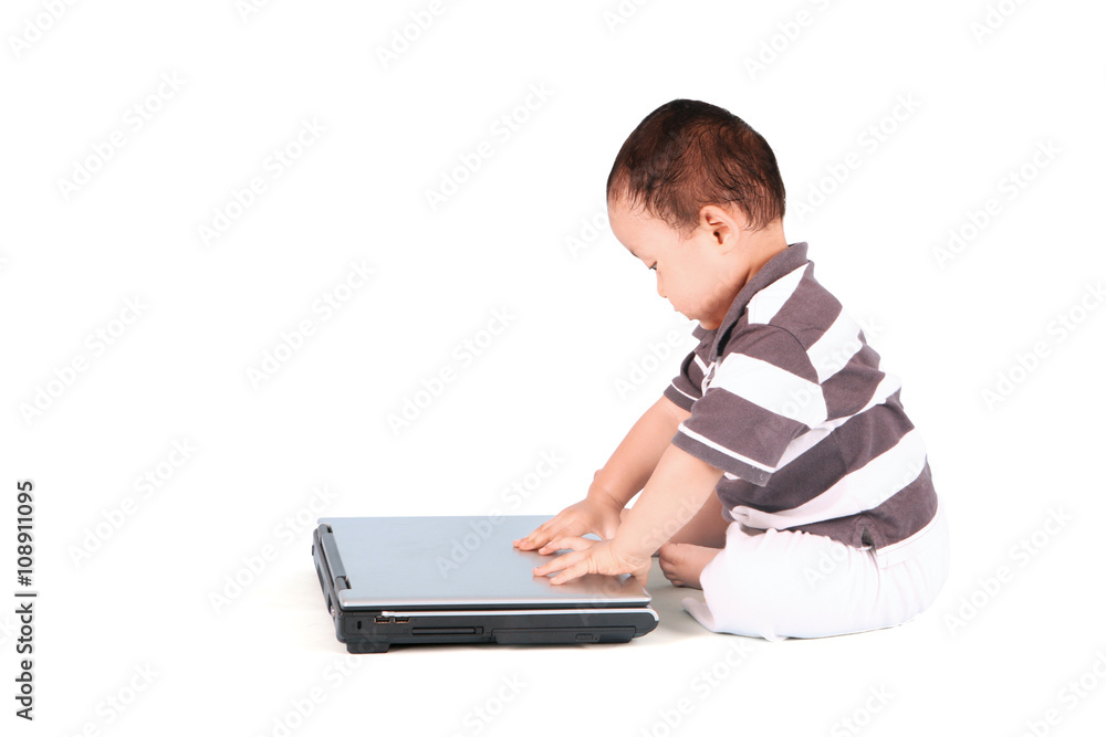Baby boy with laptop in studio Baby boy with laptop in studio