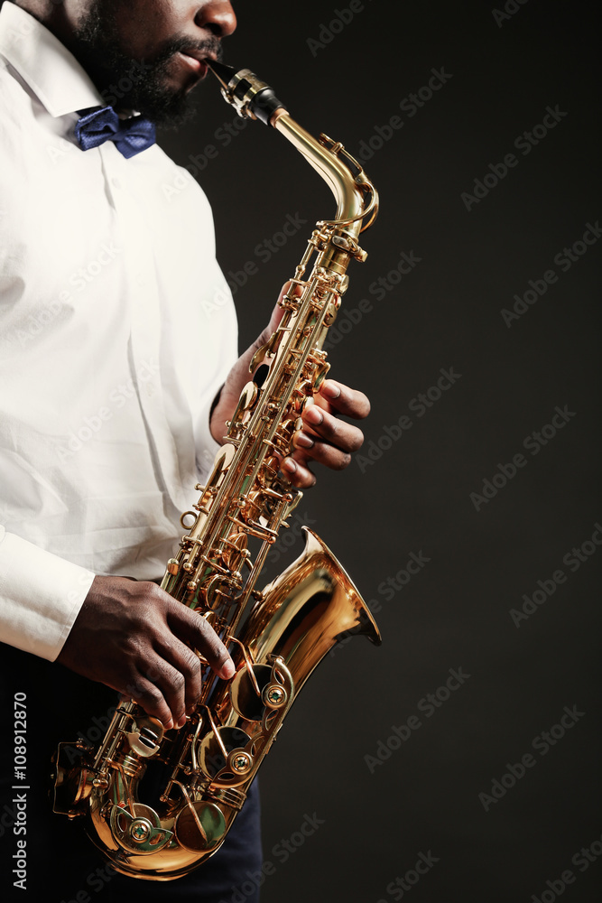 Fototapeta premium African American jazz musician playing the saxophone, closeup