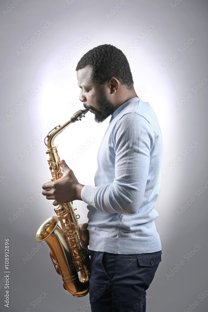 Naklejka premium African American jazz musician playing the saxophone