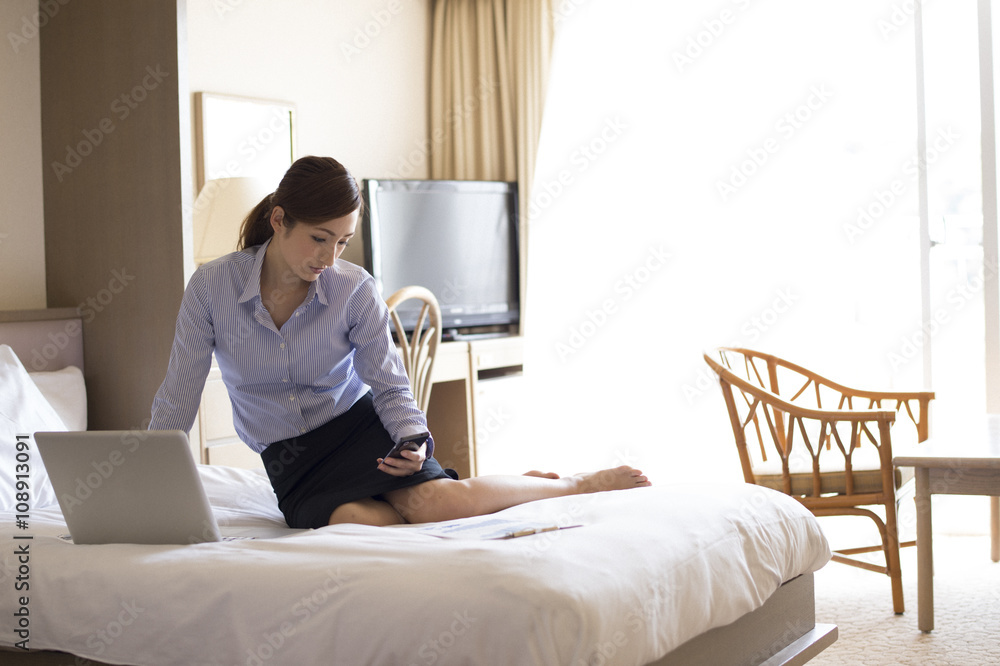Women are waiting for the contact sitting in the business hotel bed Women are waiting for the contact sitting in the business hotel bed