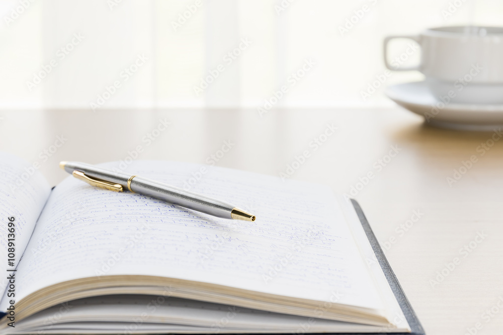 Pen put on a book with on the desk Pen put on a book with on the desk
