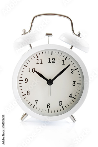 White alarm clock shows 7 after 10
