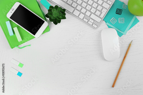 Obraz na płótnie Workplace with mobile phone, computer peripherals and stationery on light table