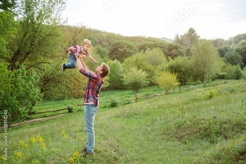 Cute little child playing outdoor with dad