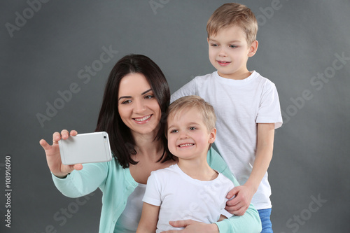 Smiling mom making selfie w...