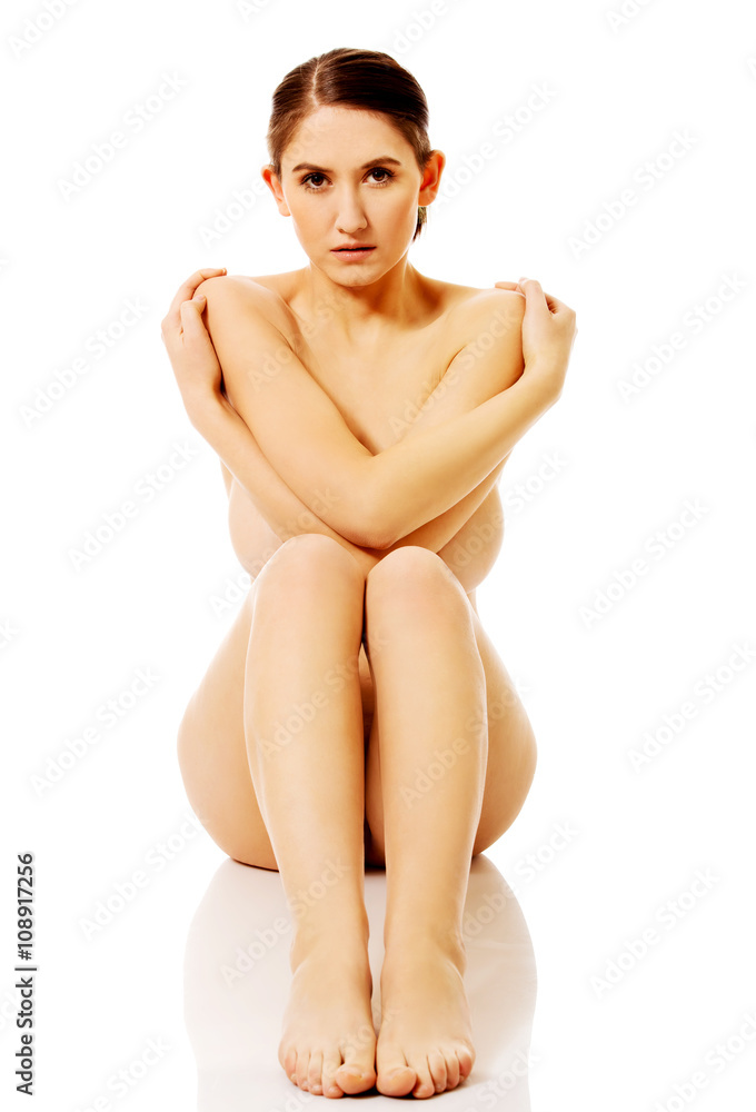 Fototapeta premium Young naked woman sitting on the floor