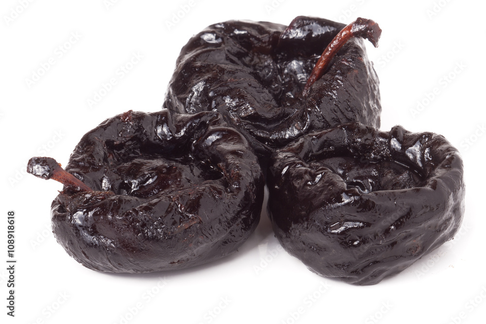three dried plums isolated on white background close-up macro three dried plums isolated on white background close-up macro