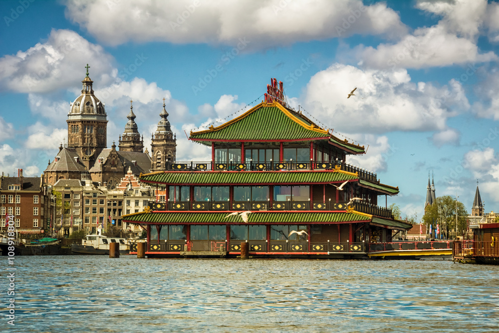 Haarzelf Componeren Miles Historical church and famous floating Chinese restaurant in Amsterdam Stock  Photo | Adobe Stock
