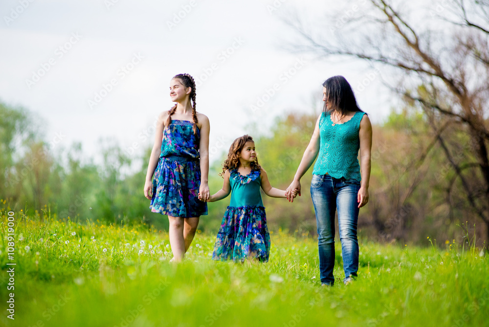 Beautiful Young Woman with Two Children in the park.