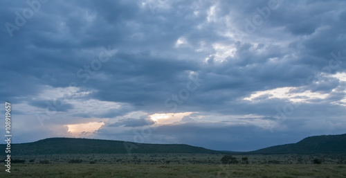 Savanna plain at dawn against storm cloud sky background. Serengeti National Park, Tanzania, Africa.    © shujaa_777