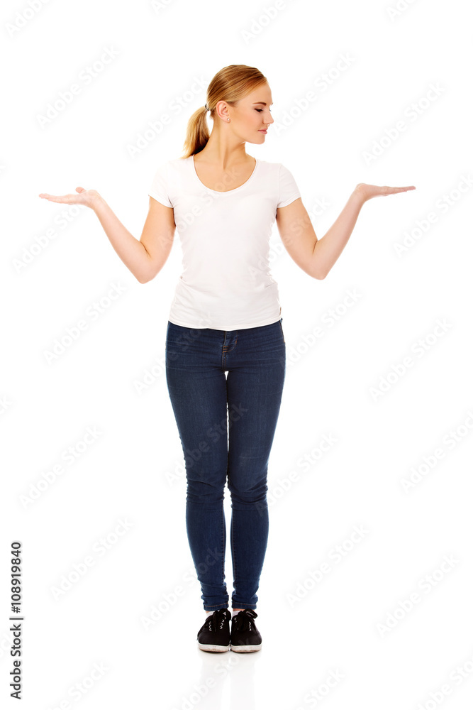 Young woman presenting something on open palms Young woman presenting something on open palms