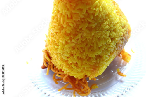 typical food in Kalimantan namely yellow rice, presented in a transparent plate and ready to eat in the morning photo