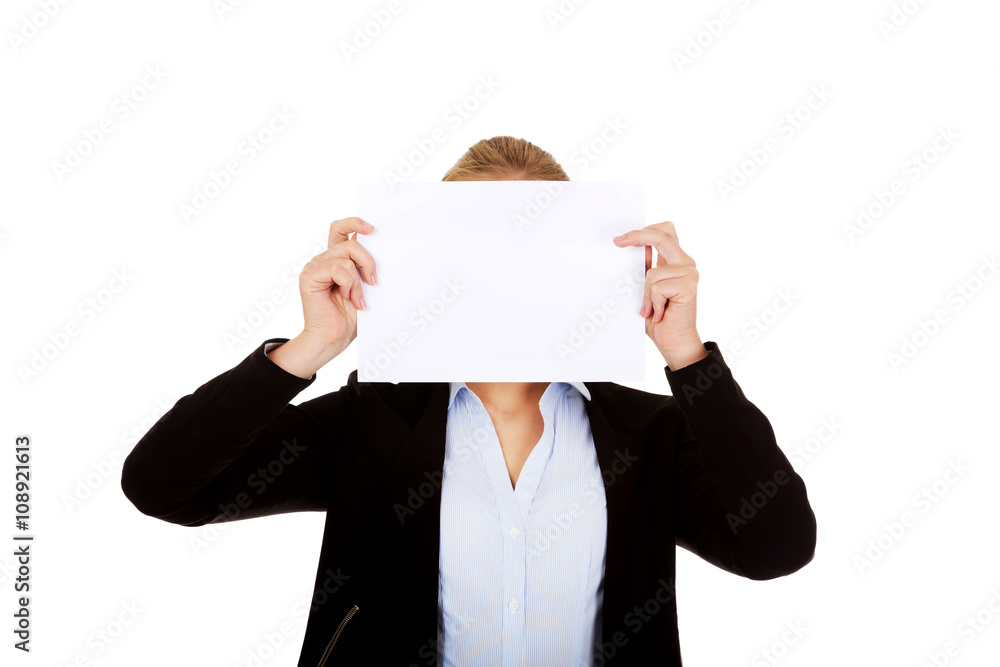 Business woman covering face with blank paper card Business woman covering face with blank paper card