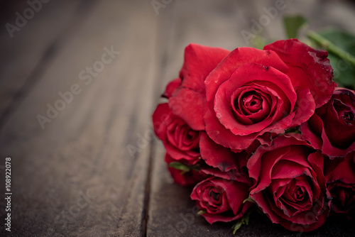 Red roses on wood background Retro vintage  Valentines Day