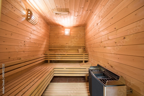 Large standard-design Finland-style classic wooden sauna interior in public building, hotel