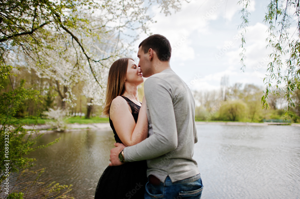 Young couple in love outdoor. Boy kiss nose of his girl Young couple in love outdoor. Boy kiss nose of his girl