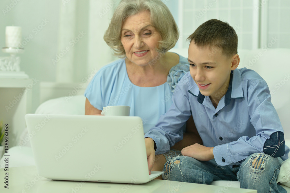 grandmother and boy with laptop