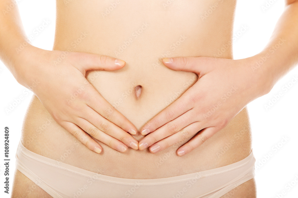 Woman is having heart shape made from hands on her belly Woman is having heart shape made from hands on her belly