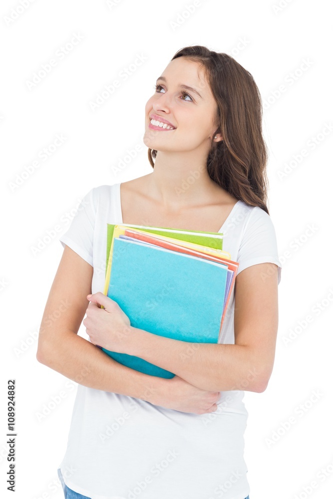 Smiling female college student holding books Smiling female college student holding books