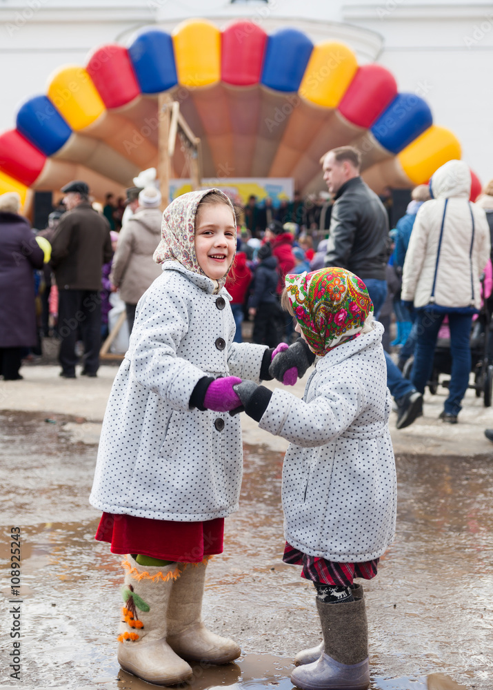  two sisters on  street in winter.