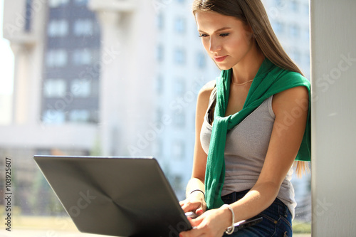 Free Download Portrait of young business woman using laptop at office - GFXLoad