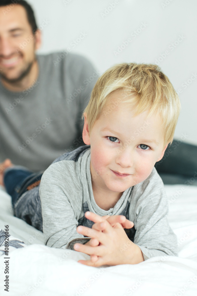 Father with son playing in bedroom Father with son playing in bedroom