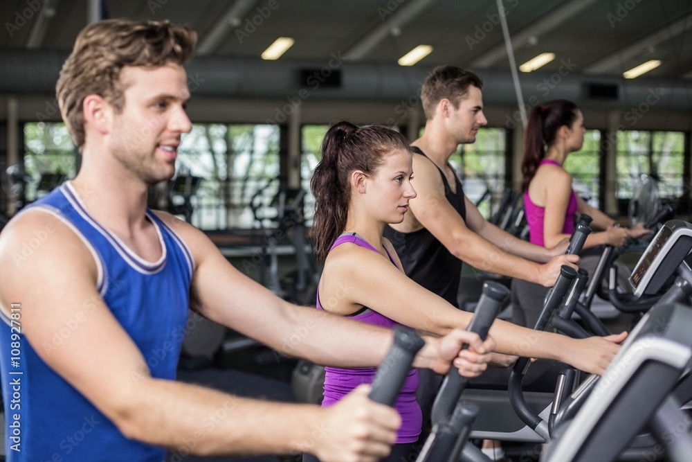 Obraz premium Fit people on elliptical bike