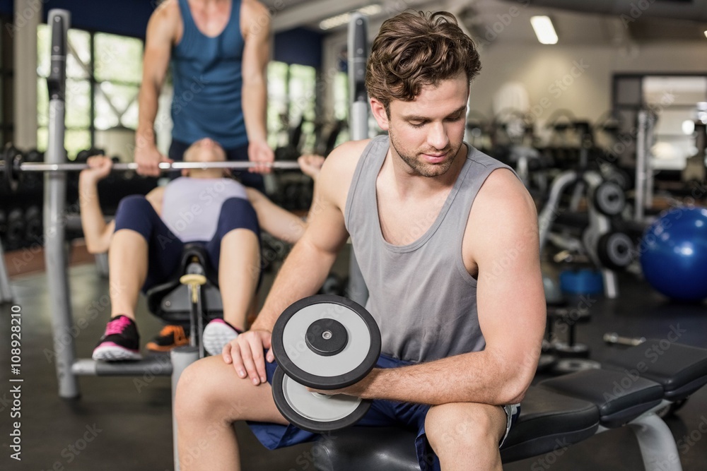 Fit man lifting dumbbell Fit man lifting dumbbell