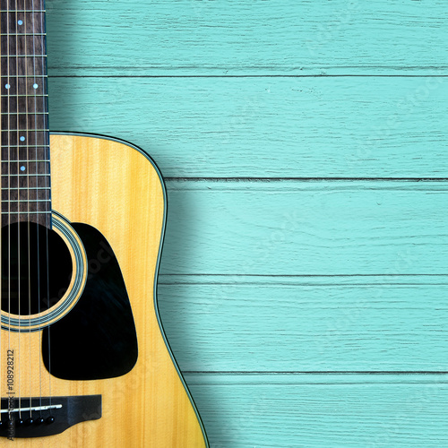 Acoustic guitar on blue wood vintage background.
