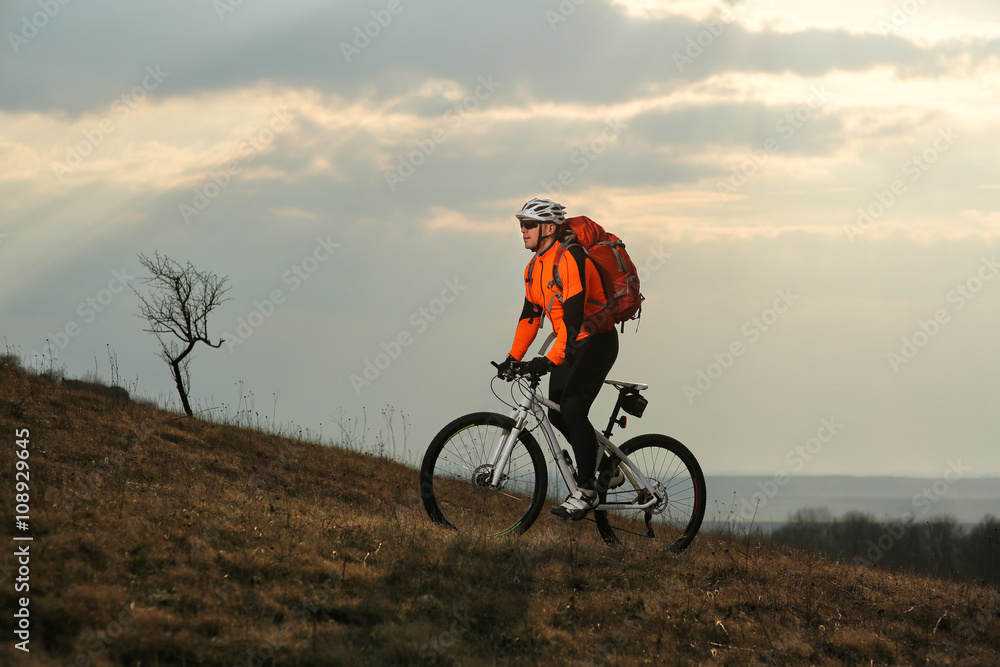 Man cyclist with backpack riding the bicycle Man cyclist with backpack riding the bicycle