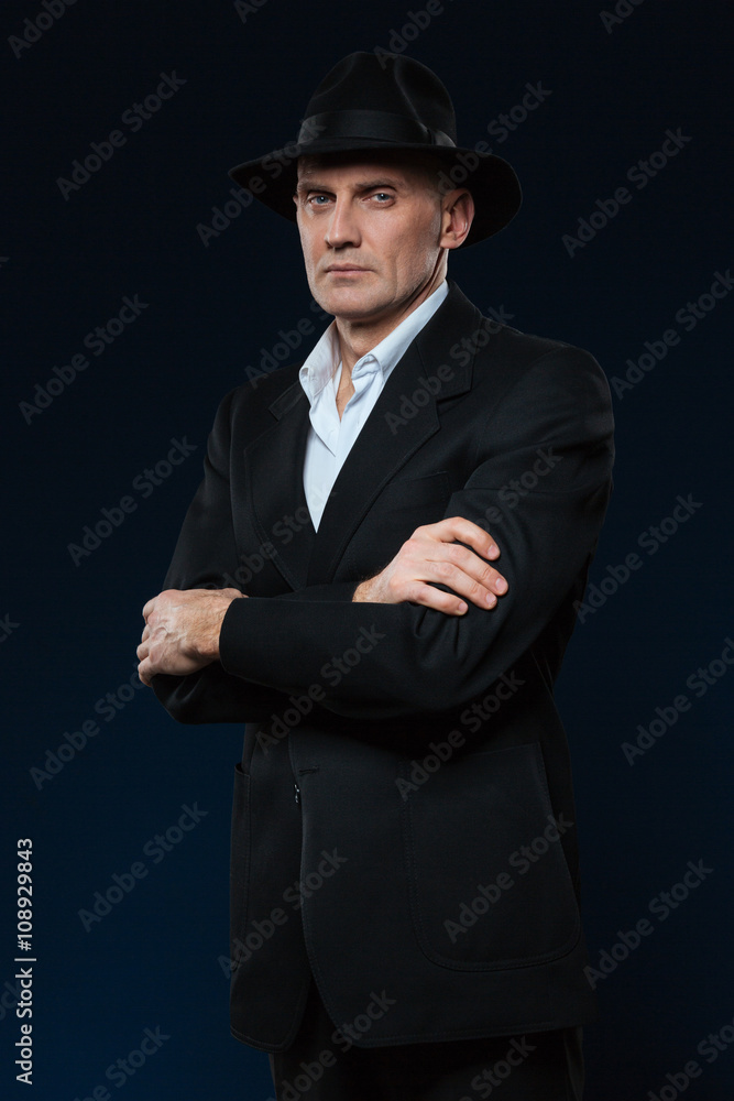 Confident businessman standing with arms folded Confident businessman standing with arms folded