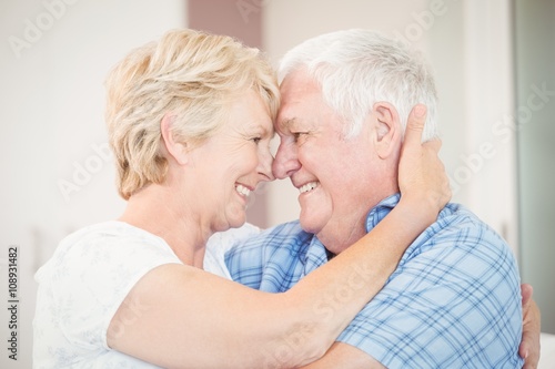 Close-up of happy senior couple embracing