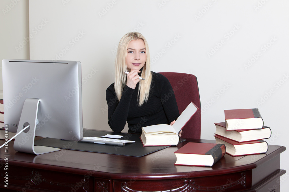 woman sitting at desk and taking notes woman sitting at desk and taking notes