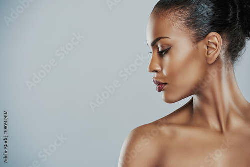 Woman looking sideways over gray background photo