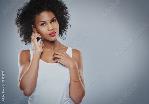 Serious Black woman with fingers by ears