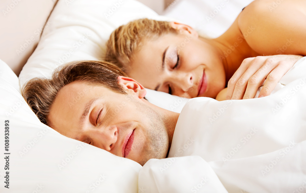 Young couple sleeping in bed Young couple sleeping in bed