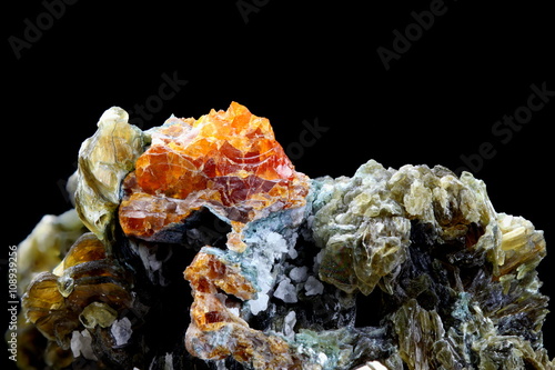 Minerals: red clinohumite and green mica photo